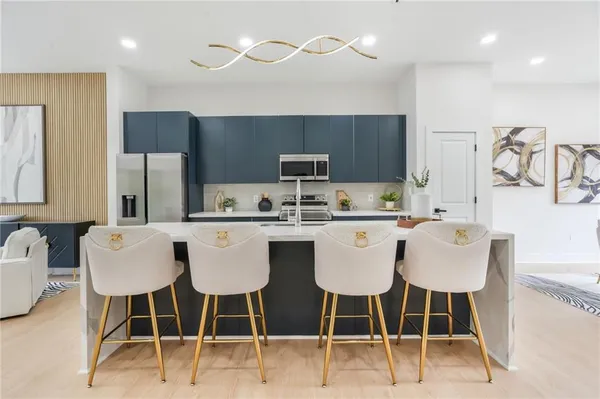 a large kitchen with a table and chairs
