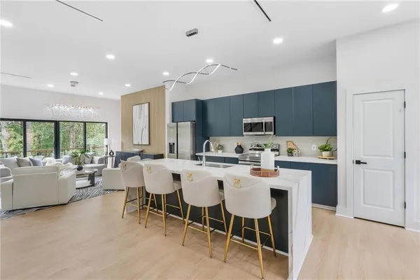 a kitchen with counter space appliances and a dining table