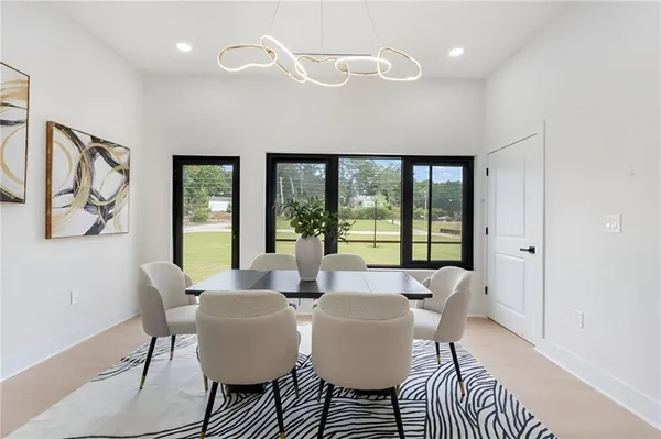 a dining room with furniture and a floor to ceiling window