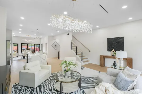 a living room with fireplace furniture and a chandelier