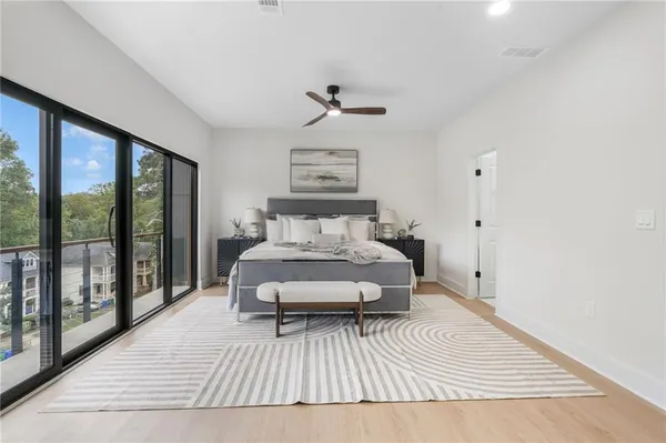 a spacious bedroom with a large bed and a large window