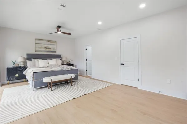 a bedroom with a large bed and a large window