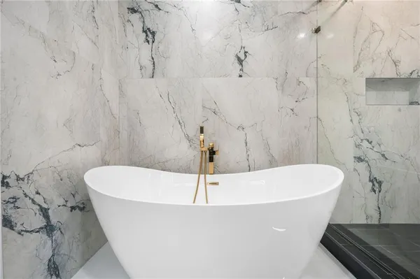 a bathroom with a granite countertop sink a toilet and shower