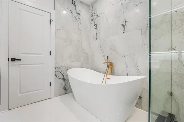 a spacious bathroom with a granite countertop sink a toilet and shower