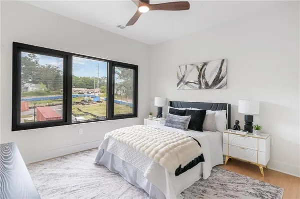 a bedroom with a bed and a table chair