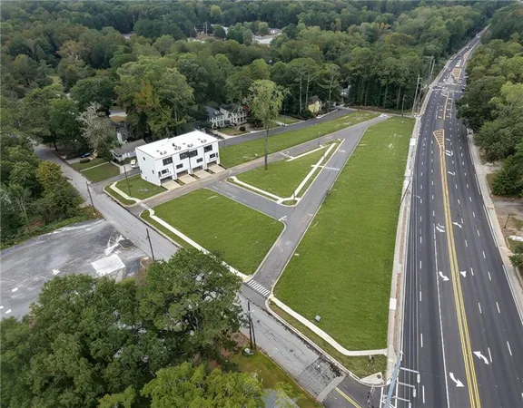 a kitchen with stainless steel appliances a sink a stove a refrigerator cabinets and a counter top space