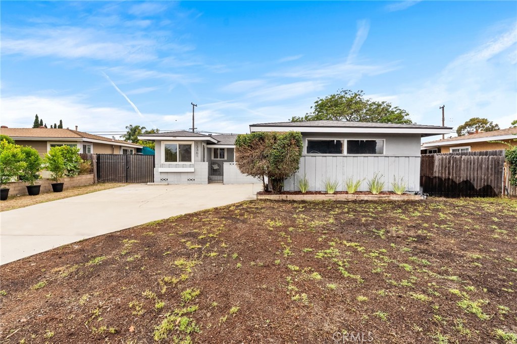 13361 Roxey Drive Garden Grove, CA 92843 - Photo 2 of 31 a front view of a house with a yard and potted plants