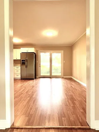 a view of a hallway with wooden floor