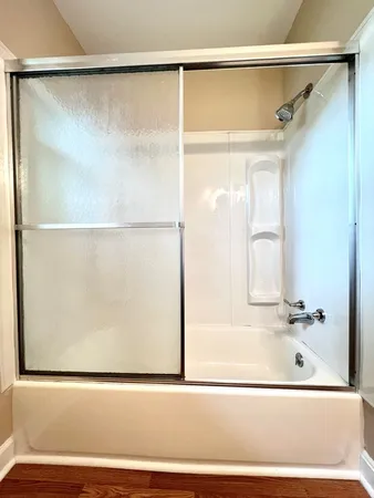 a bathroom with a toilet mirror on vanity and a sink