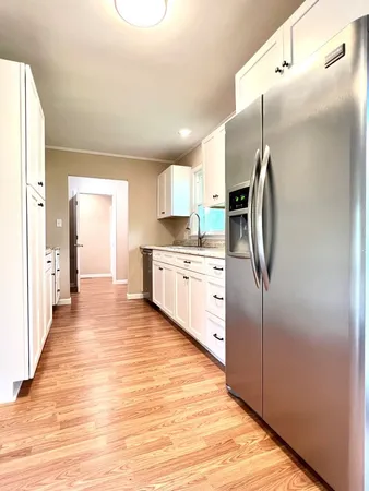 a kitchen with stainless steel appliances a refrigerator and a sink
