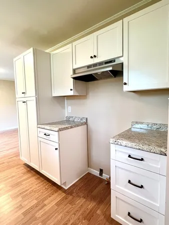 a kitchen with stainless steel appliances granite countertop a refrigerator and a stove