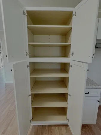a view of walk in closet with empty racks