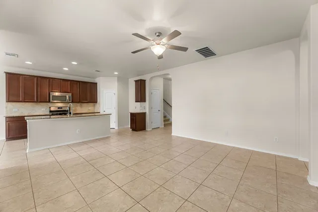 a view of kitchen with refrigerator stove microwave and cabinets