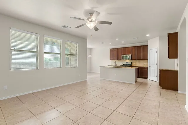 a view of kitchen with granite countertop cabinets and white appliances
