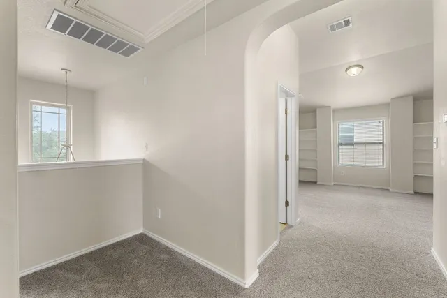 an empty room with windows and closet