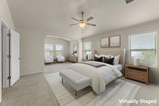 a spacious bedroom with a bed and window