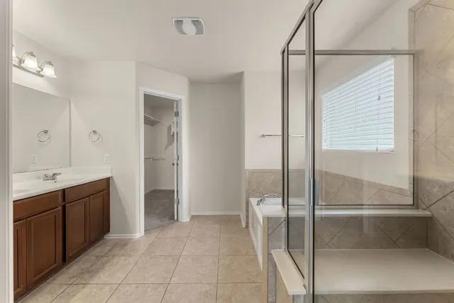 a bathroom with a double vanity sink and mirror