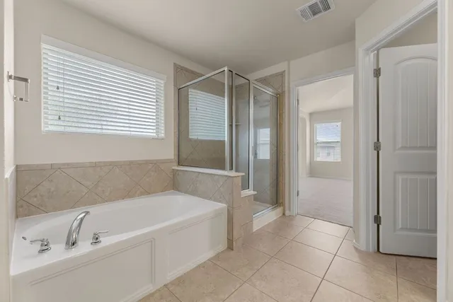 a bathroom with a bathtub and a shower