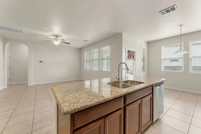 a kitchen with granite countertop a sink cabinets and window