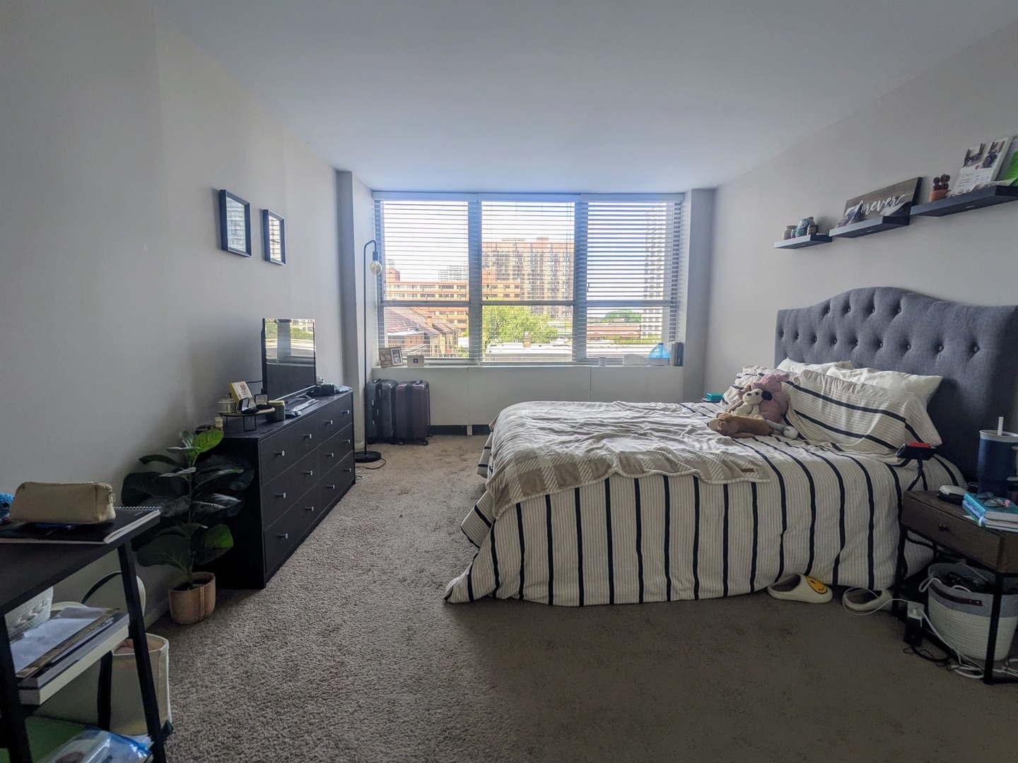 655 West Irving Park Road, Unit 508 Chicago, IL 60613 - Photo 13 of 15 a bed sitting in a bedroom next to a window