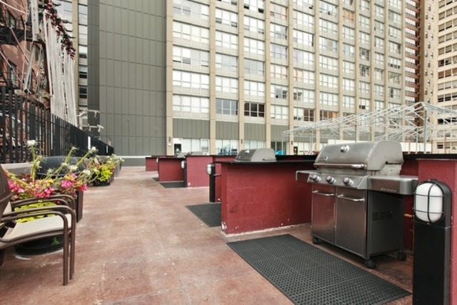 655 West Irving Park Road, Unit 508 Chicago, IL 60613 - Photo 6 of 15 a view of a lobby with chair and tables