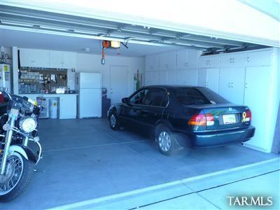 8421 Red Rock Ridge Court Tucson, AZ 85742 - Photo 8 of 16 a car parked in garage