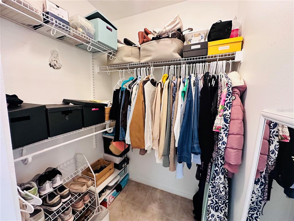 3840 Marietta Way St. Cloud, FL 34772 - Photo 11 of 44 a view of walk in closet with clothes and shoes