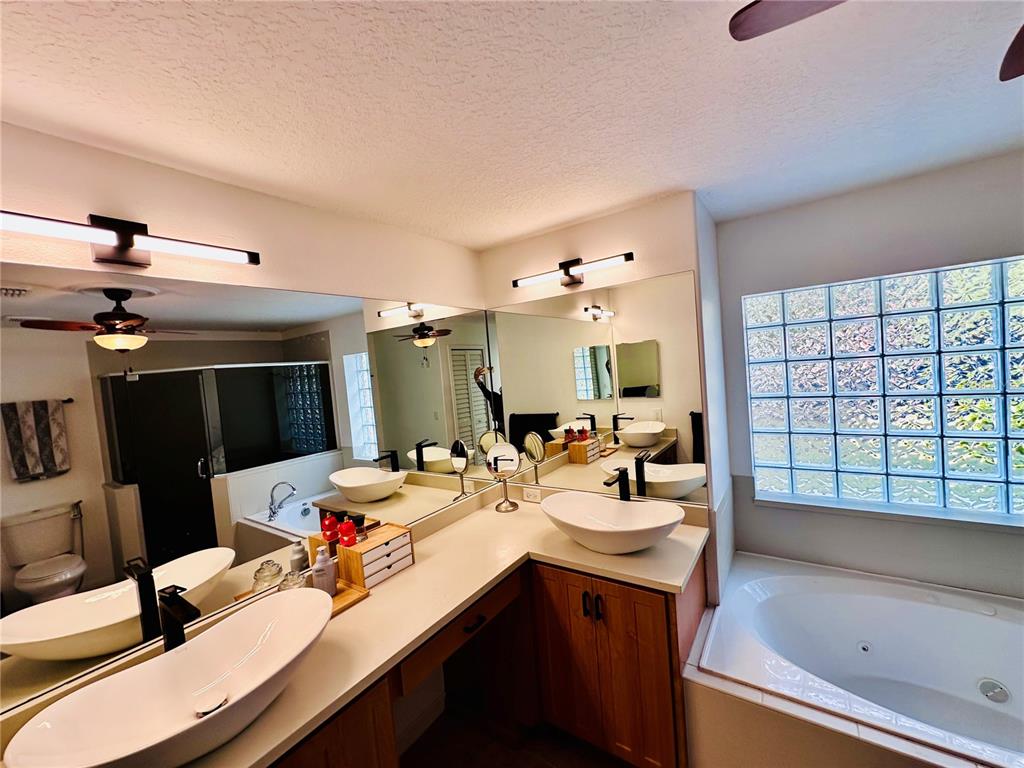 3840 Marietta Way St. Cloud, FL 34772 - Photo 12 of 44 a bathroom with a sink double vanity and a bathtub