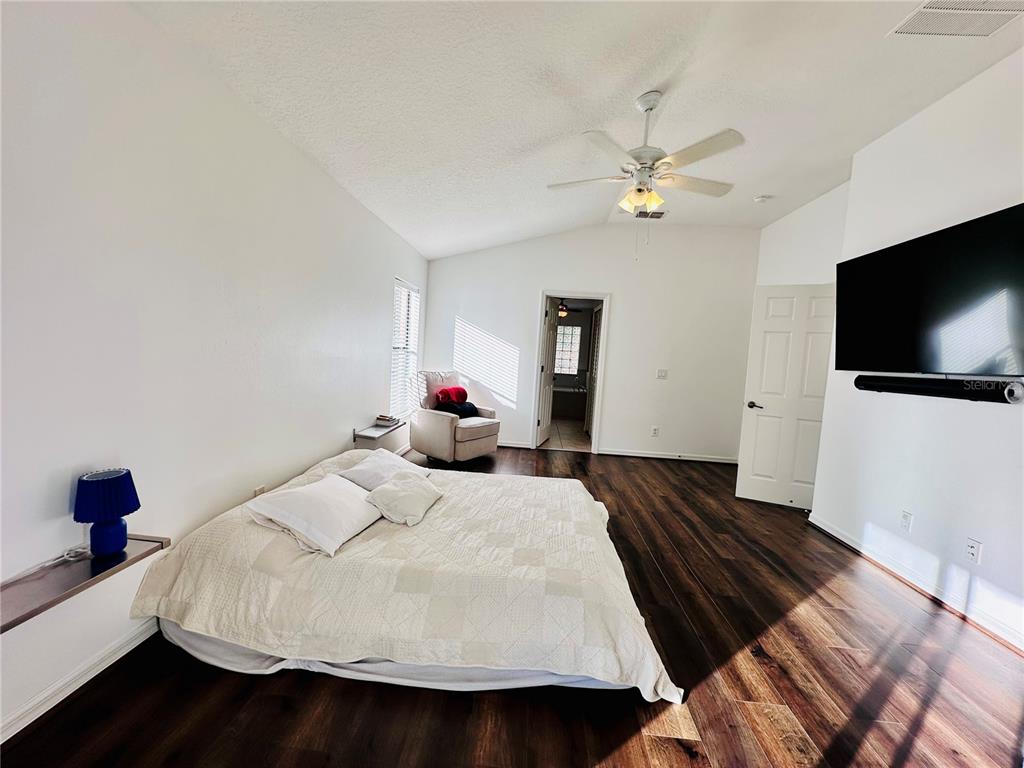 3840 Marietta Way St. Cloud, FL 34772 - Photo 15 of 44 a bedroom with a bed and a flat screen tv