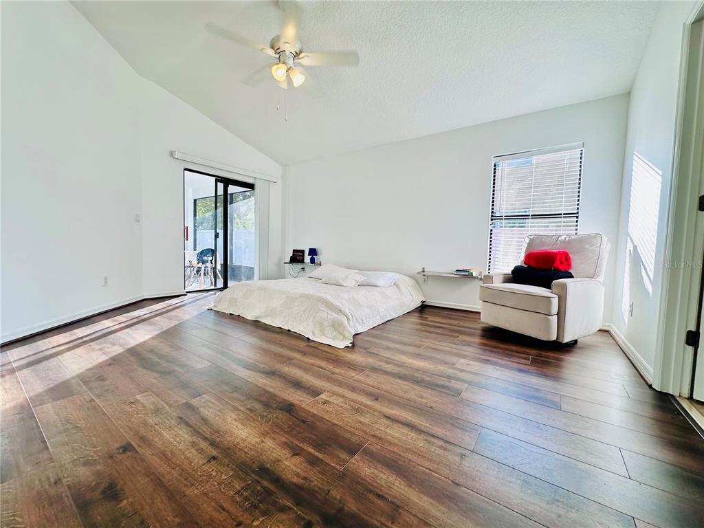 3840 Marietta Way St. Cloud, FL 34772 - Photo 16 of 44 a bedroom with a bed a couch and a window