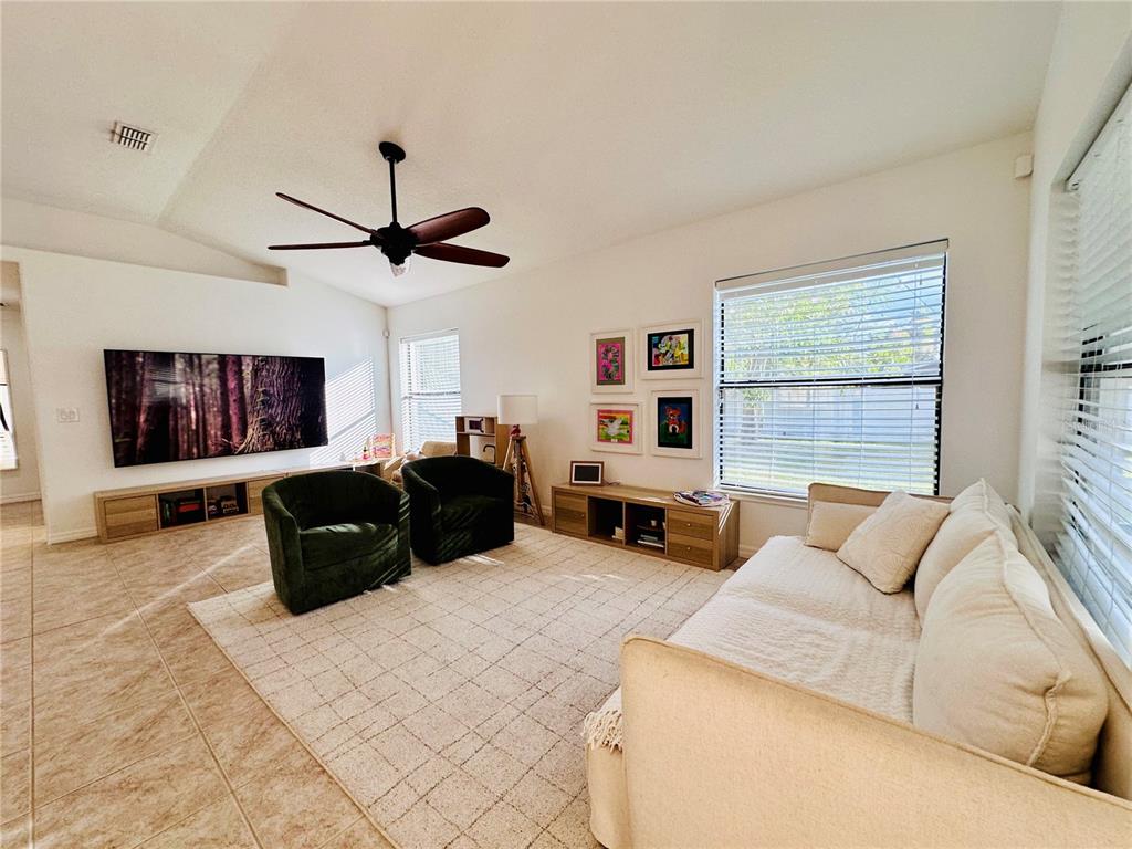 3840 Marietta Way St. Cloud, FL 34772 - Photo 18 of 44 a living room with furniture ceiling window and a flat screen tv