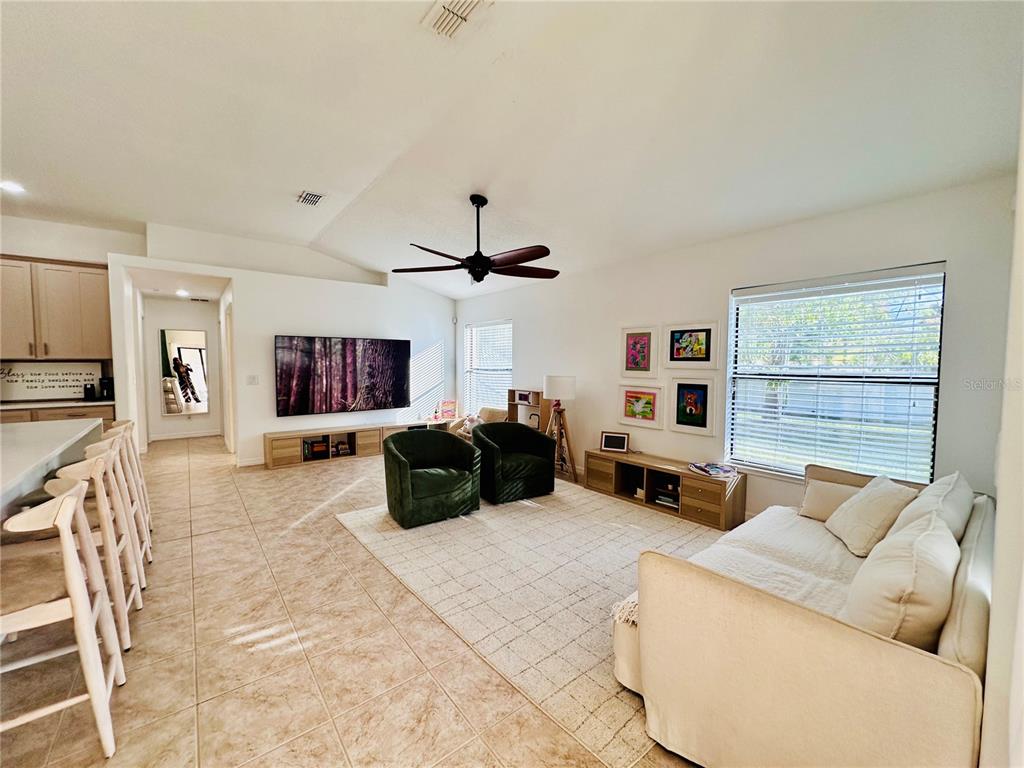 3840 Marietta Way St. Cloud, FL 34772 - Photo 20 of 44 a living room with furniture and a flat screen tv