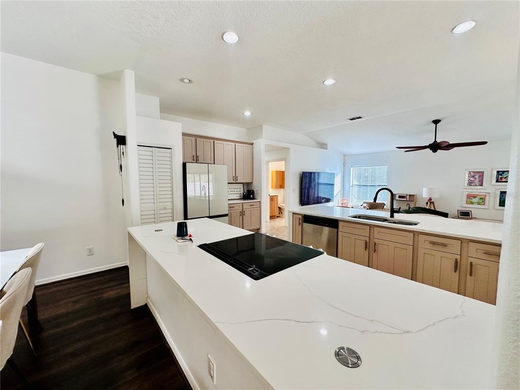 3840 Marietta Way St. Cloud, FL 34772 - Photo 28 of 44 a kitchen with a sink a stove and refrigerator