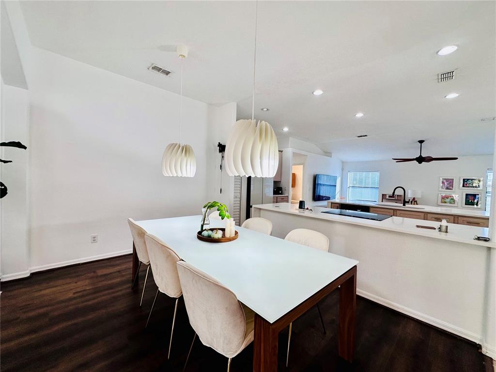 3840 Marietta Way St. Cloud, FL 34772 - Photo 33 of 44 a kitchen with a dining table chairs and white cabinets