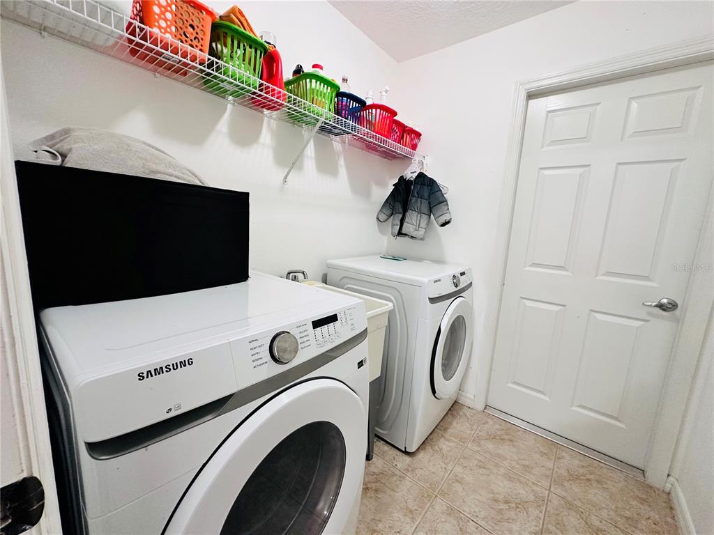 3840 Marietta Way St. Cloud, FL 34772 - Photo 4 of 44 a utility room with dryer and washer