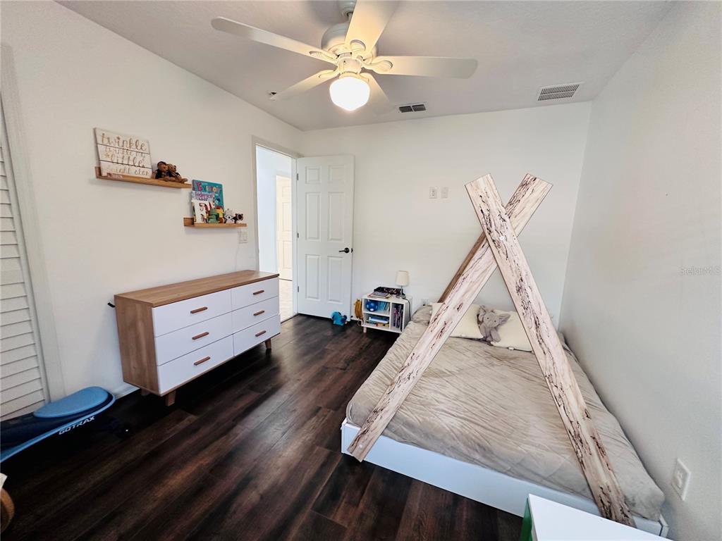 3840 Marietta Way St. Cloud, FL 34772 - Photo 5 of 44 a living room with furniture and a wooden floor