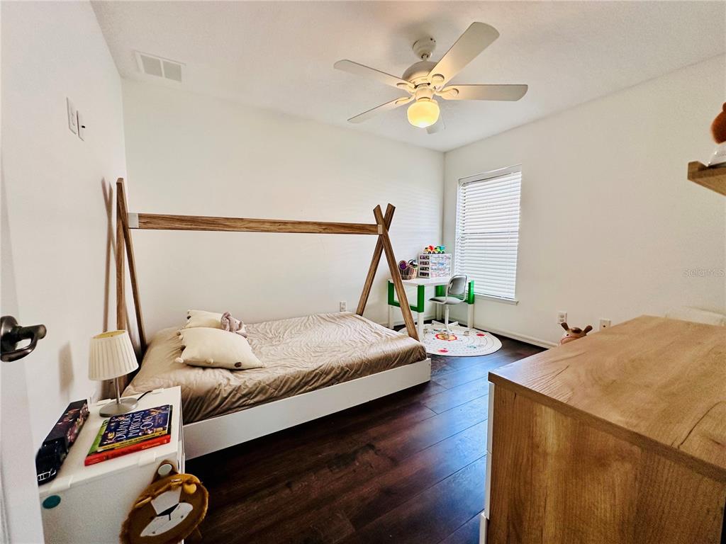 3840 Marietta Way St. Cloud, FL 34772 - Photo 6 of 44 a bedroom with a bed and a chandelier