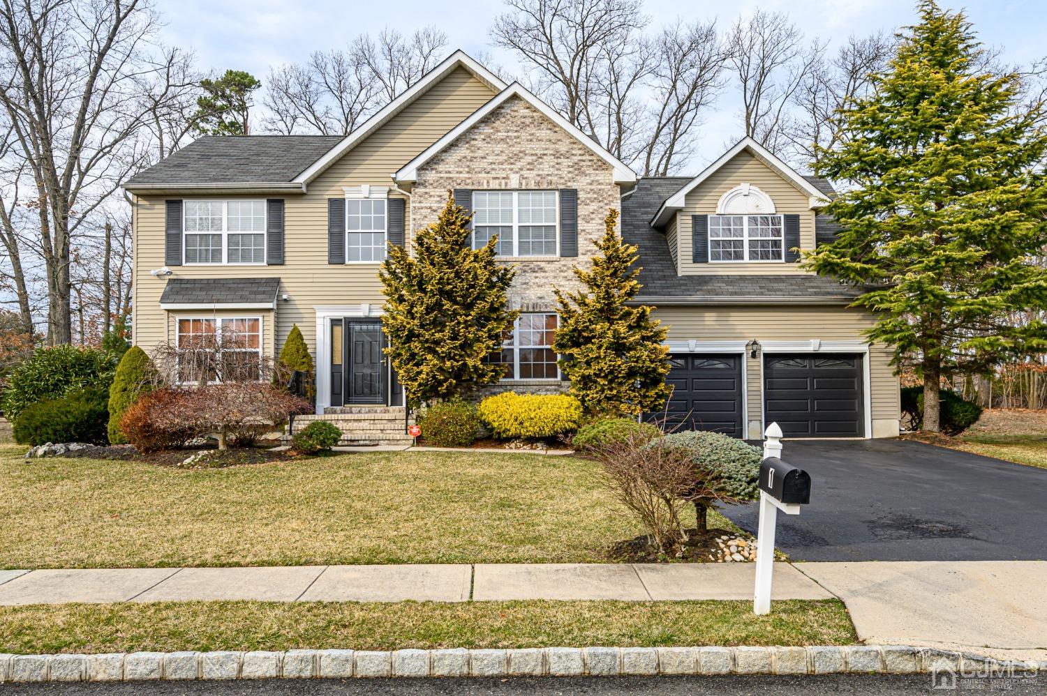 1 Rutgers Drive Howell, NJ 07731 - Photo 1 of 43 a front view of a house with a yard and garage