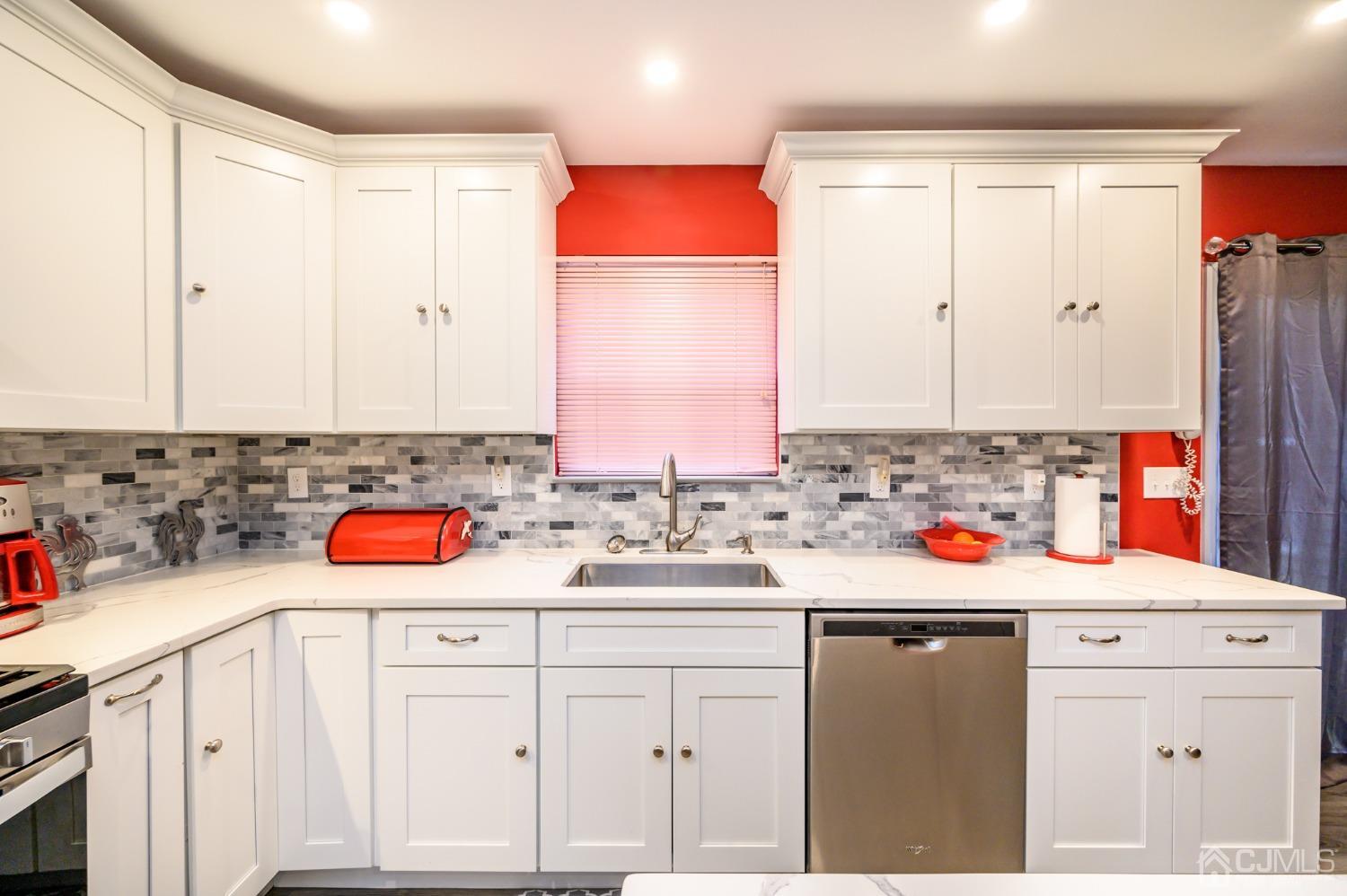 1 Rutgers Drive Howell, NJ 07731 - Photo 13 of 43 a kitchen with a sink stove and cabinets