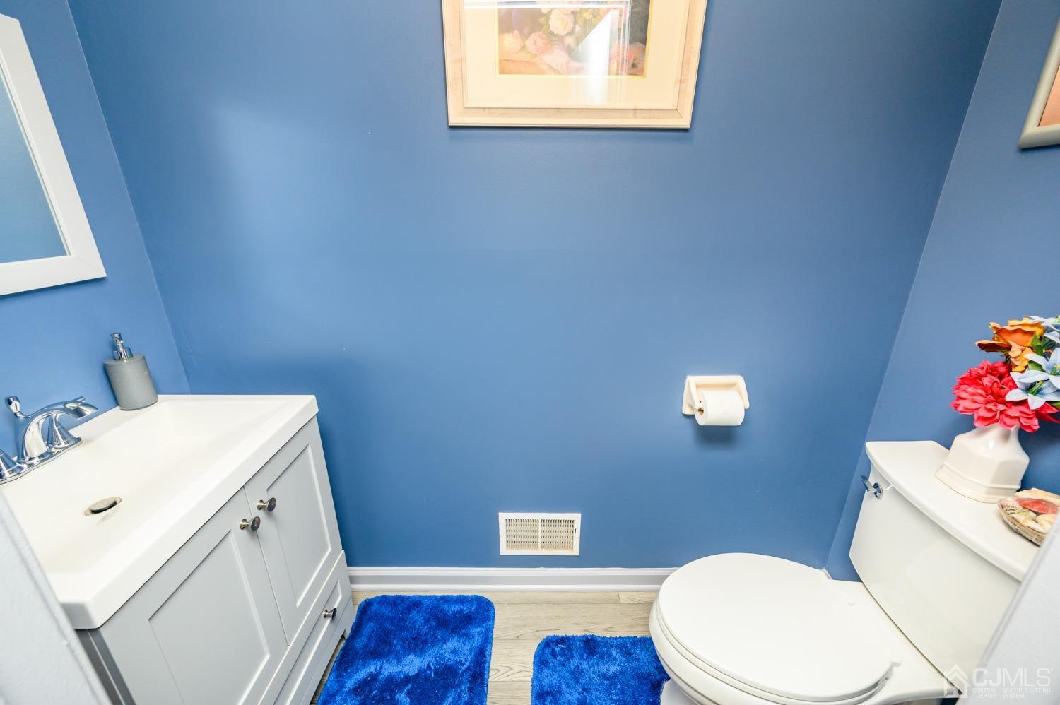 1 Rutgers Drive Howell, NJ 07731 - Photo 19 of 43 a bathroom with a sink a toilet and a mirror