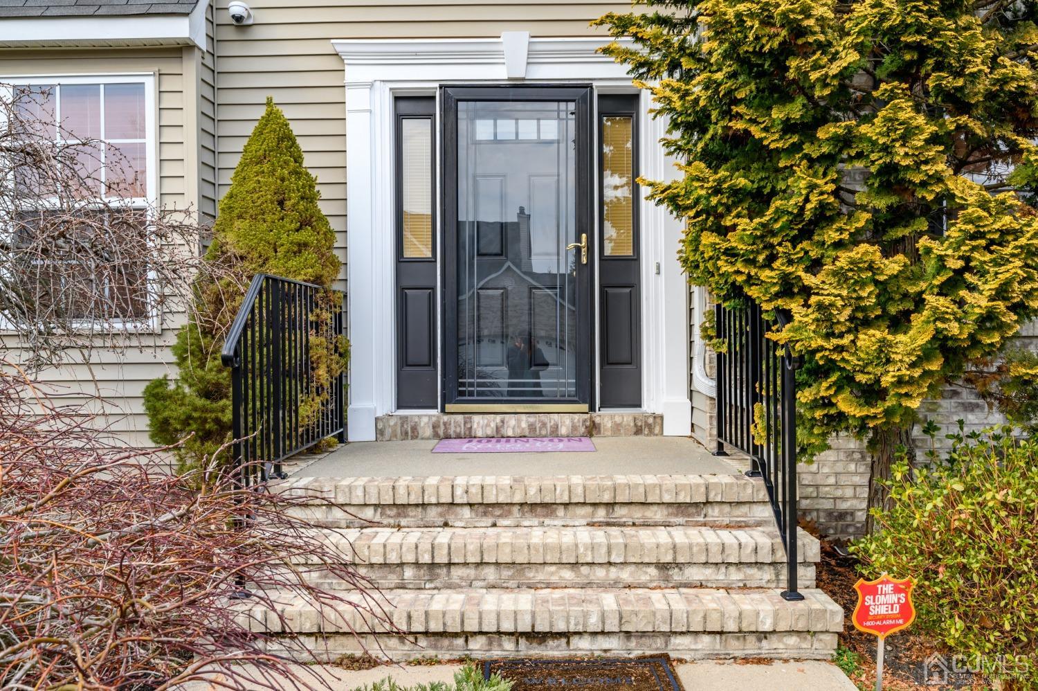 1 Rutgers Drive Howell, NJ 07731 - Photo 2 of 43 a front view of a house with a garden