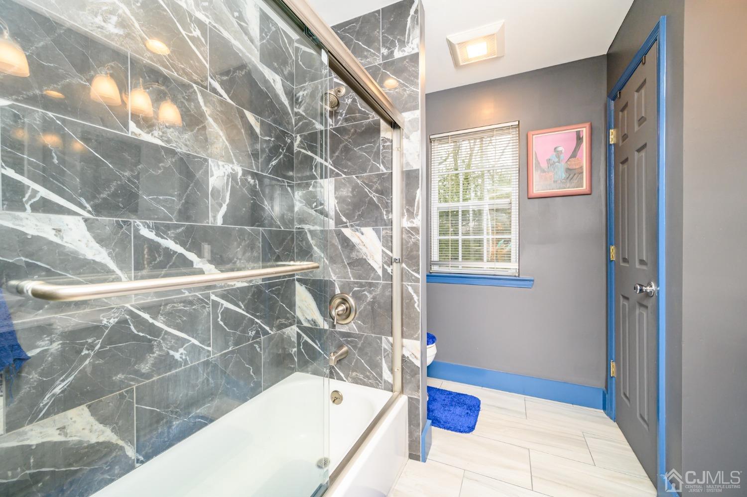 1 Rutgers Drive Howell, NJ 07731 - Photo 27 of 43 a bathroom with a bathtub and window