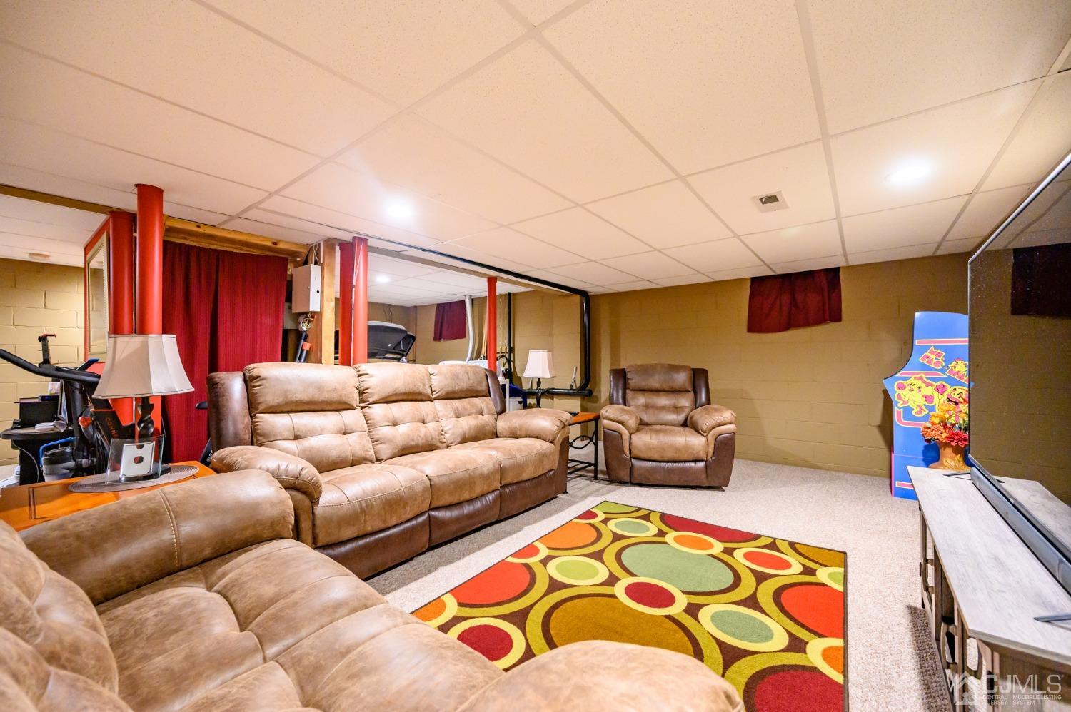 1 Rutgers Drive Howell, NJ 07731 - Photo 36 of 43 a living room with furniture and a flat screen tv