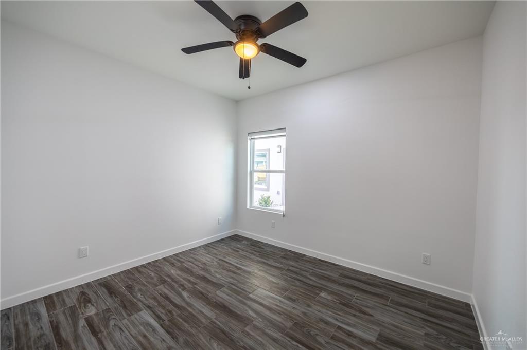 1106 Copper Avenue, Unit 4 San Juan, TX 78589 - Photo 16 of 20 an empty room with a window and a ceiling fan