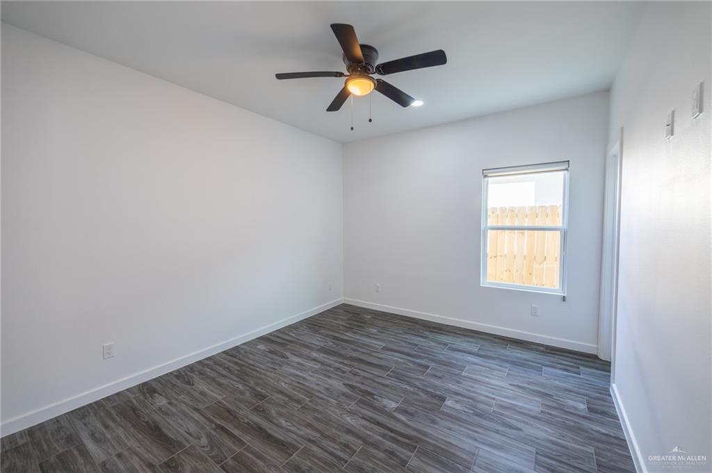 1106 Copper Avenue, Unit 4 San Juan, TX 78589 - Photo 17 of 20 wooden floor in an empty room with a window
