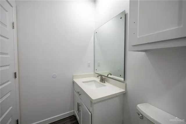a bathroom with a sink toilet and vanity