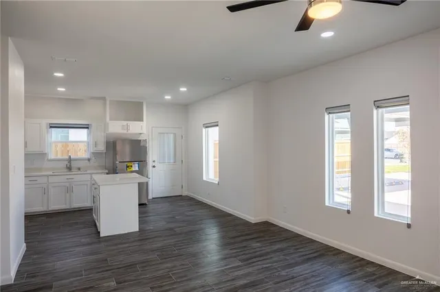 a kitchen with a wooden floor and window