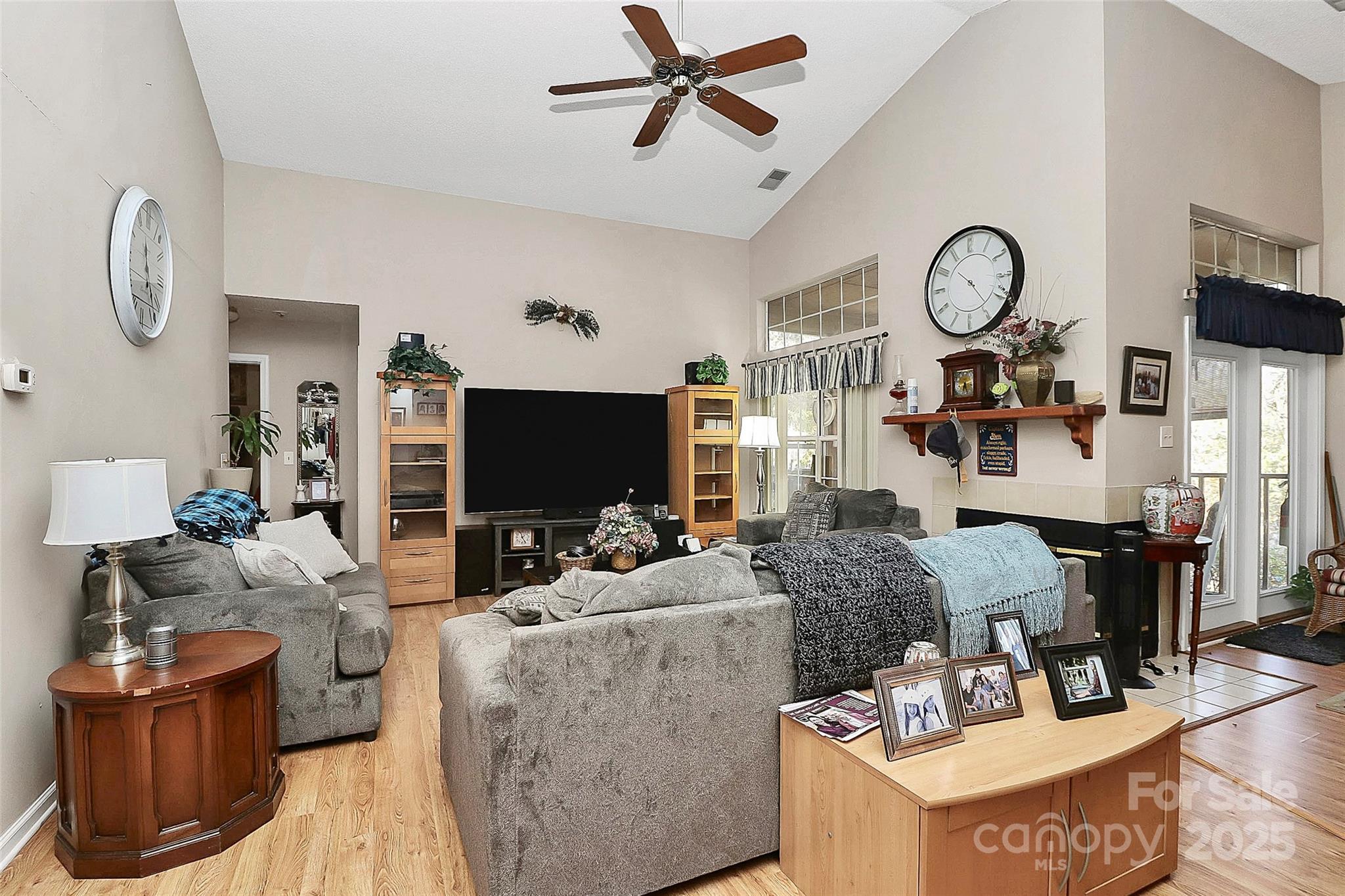 493 Debra Circle Southwest Concord, NC 28025 - Photo 5 of 27 a living room with furniture a clock tv and a window