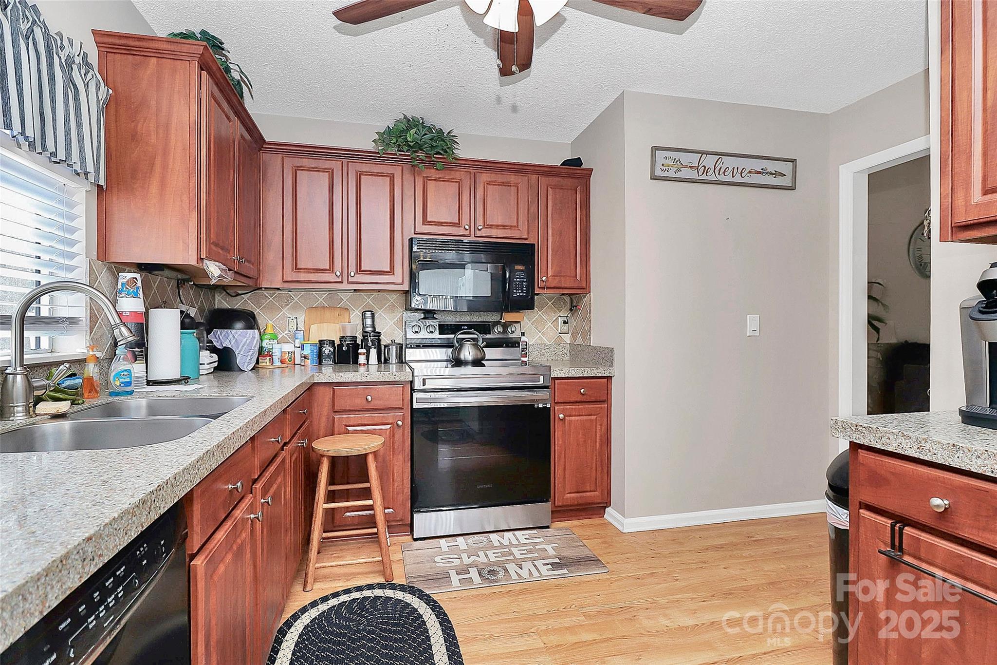 493 Debra Circle Southwest Concord, NC 28025 - Photo 9 of 27 a kitchen with stainless steel appliances granite countertop a refrigerator a stove top oven a sink and dishwasher