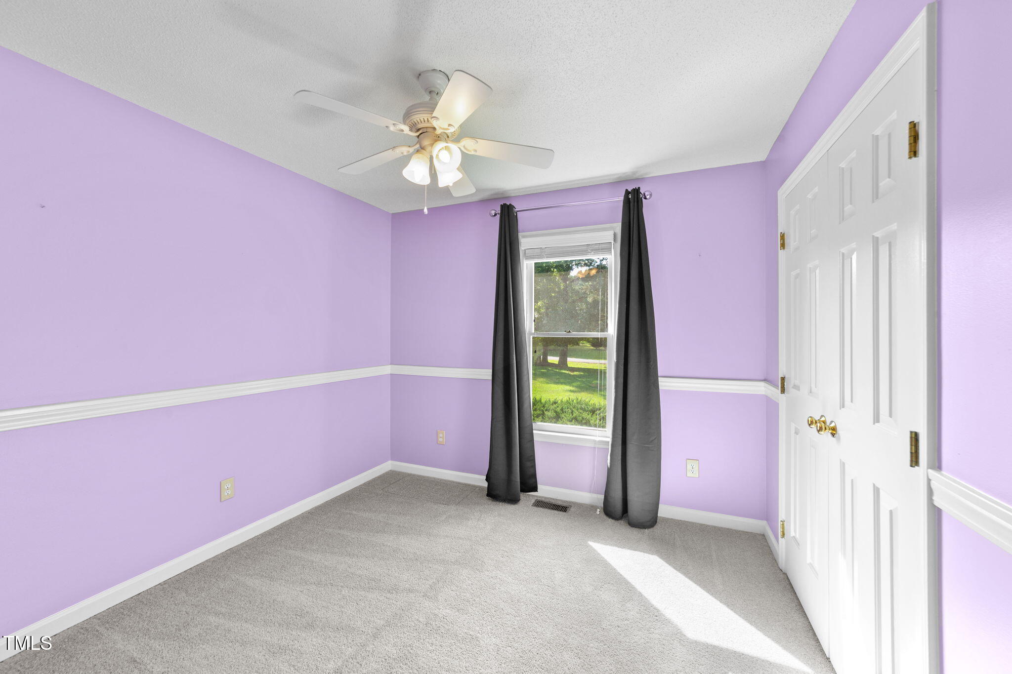 2712 Quail Point Drive Raleigh, NC 27603 - Photo 14 of 25 a view of a livingroom with a chandelier fan and windows